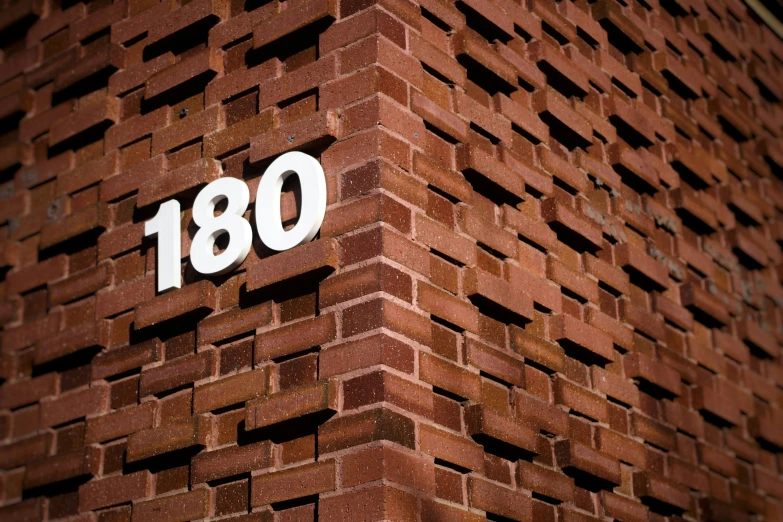 there is an old brick building with the numbers 180 on it