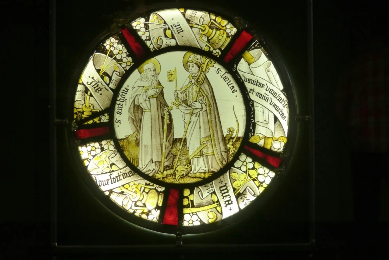 a stained glass window that shows two people