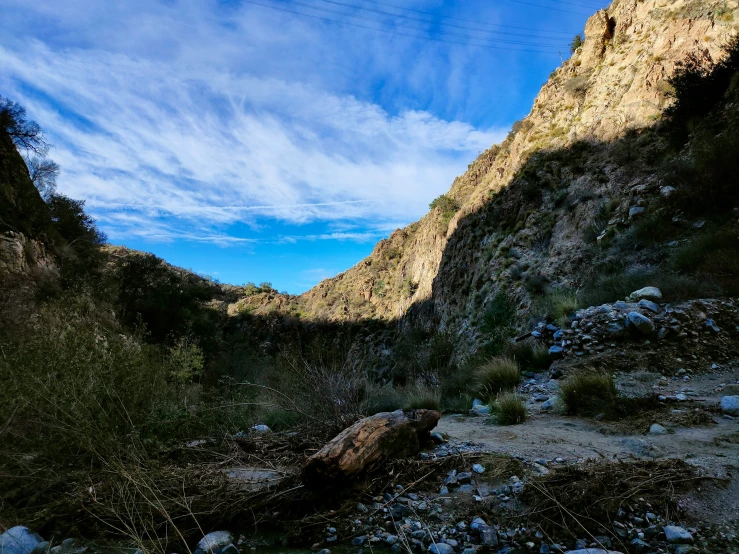 a view from the ground in a canyon that is under rocks and water