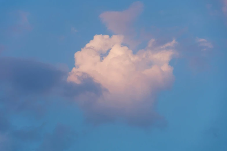 a large cloud that is over a clock tower