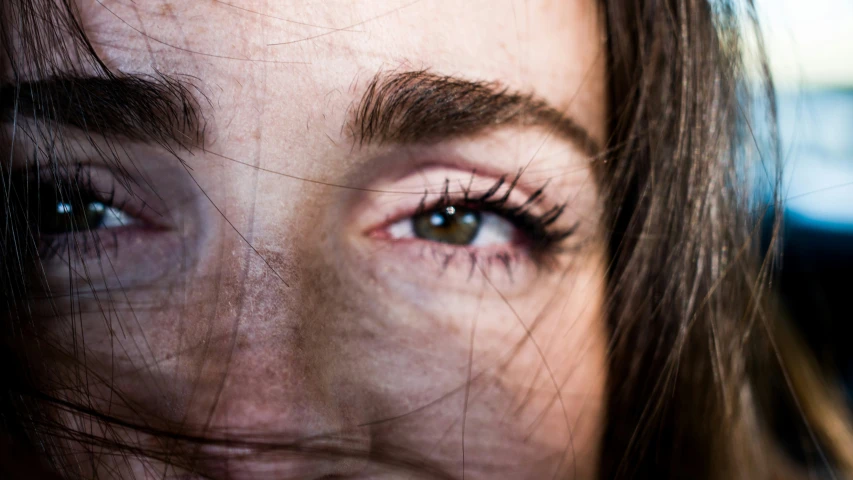 the woman has long, brown hair and blue eyes