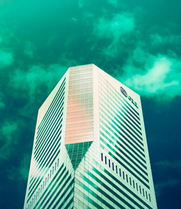 the top of a building against a blue sky with white clouds