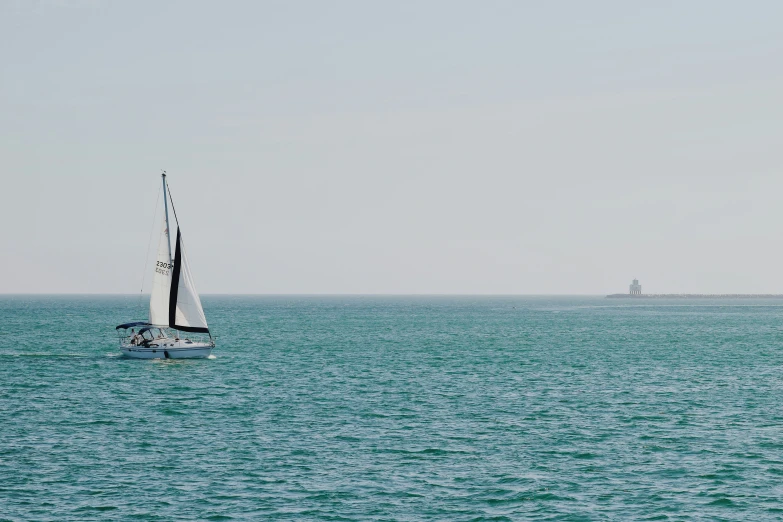 a boat sailing in a clear blue sea