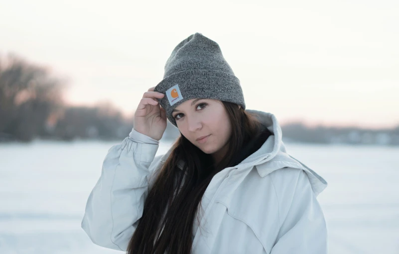 a woman with long hair wearing a hat