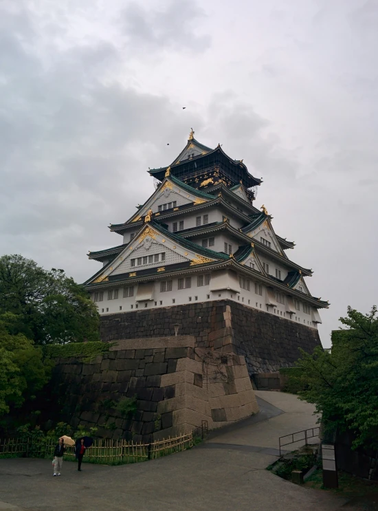 two people standing in front of an elaborately made structure