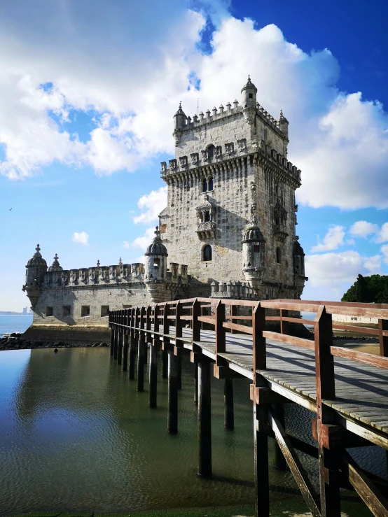 an old building is sitting on the edge of water