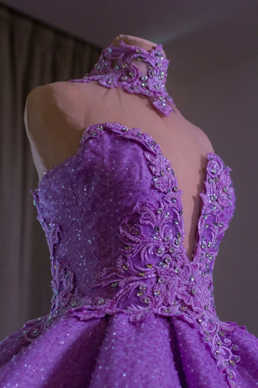 a purple dress that has a big beaded neck