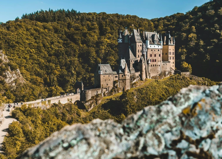 an old castle with mountains in the background