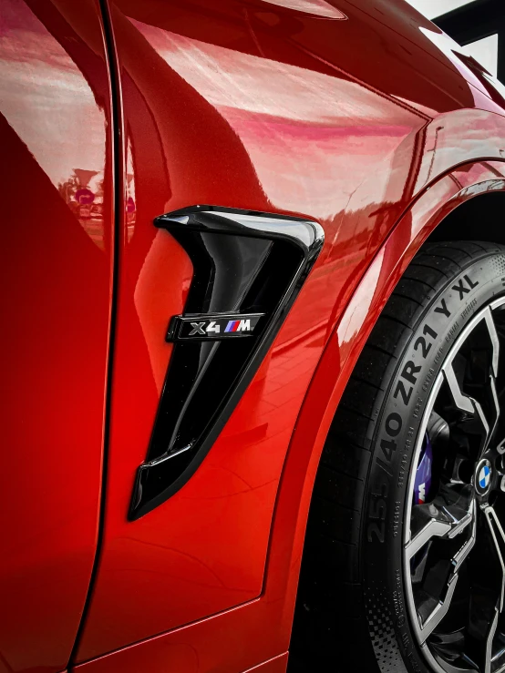 a close up view of a red car's wheel