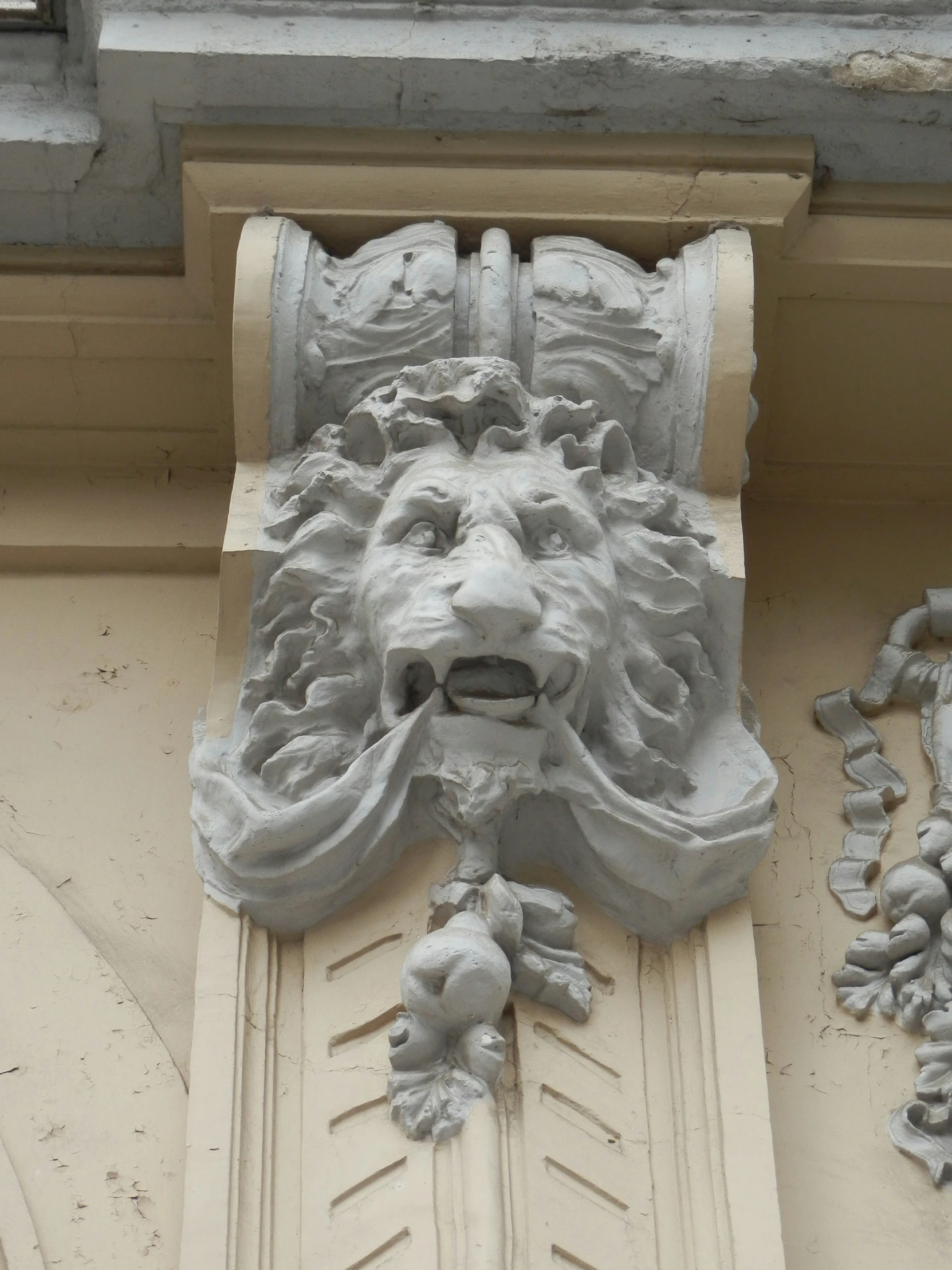 the face of a lion on a building