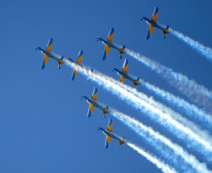 a flock of airplanes that are flying in the sky