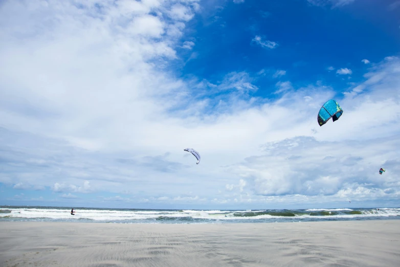 a kite flies high into the air on the beach