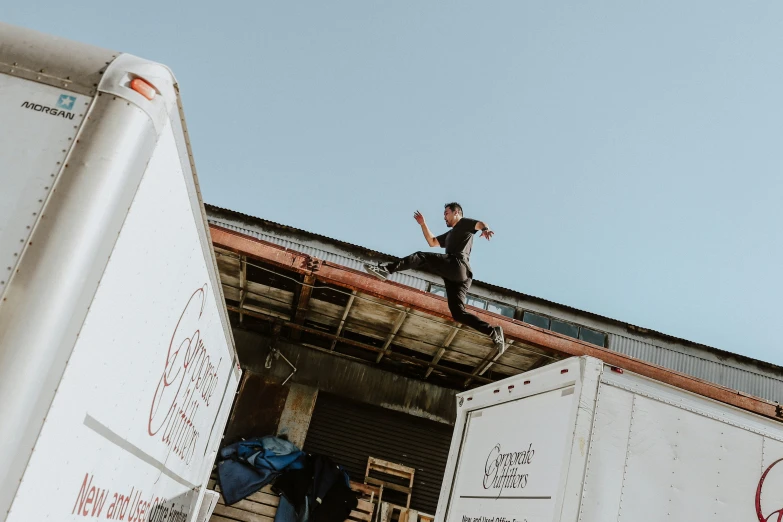 a man on top of the roof of an industrial building