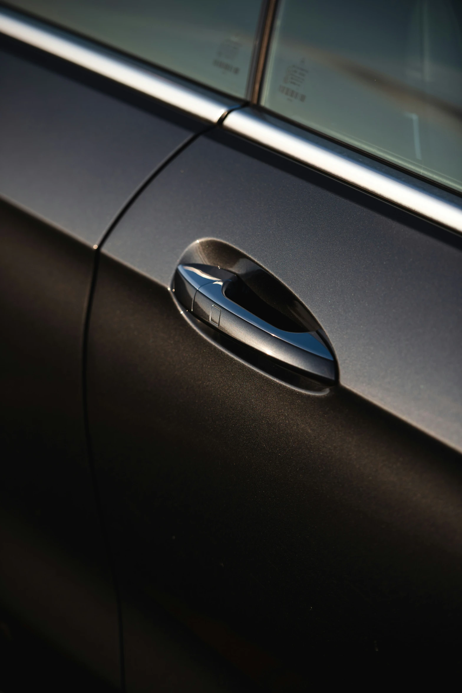 door handle with black background and reflection on window