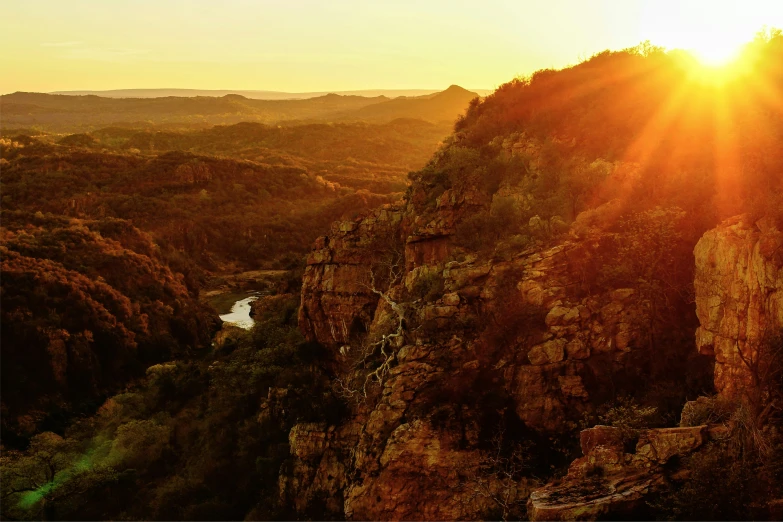 the sun rises over the canyons on a clear day