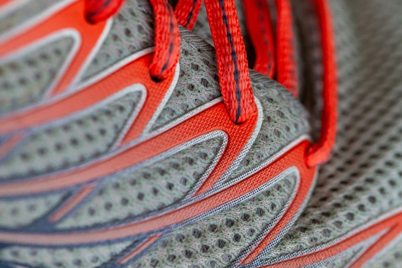 the sole of a red and grey running shoe