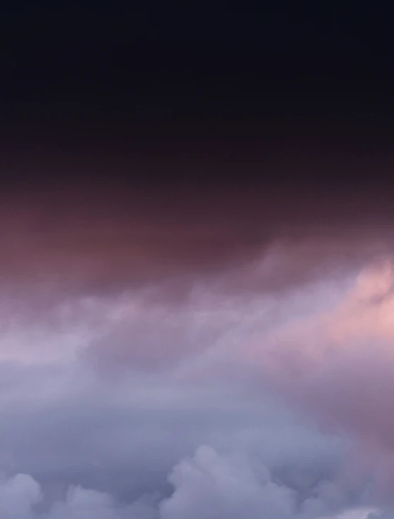 a view of two planes and clouds at night