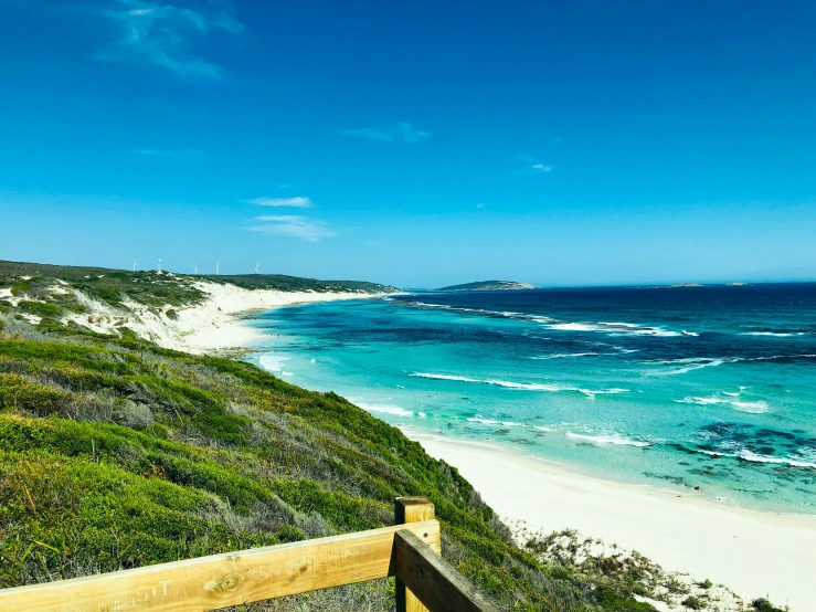 blue and white water near the beach as seen from an incline