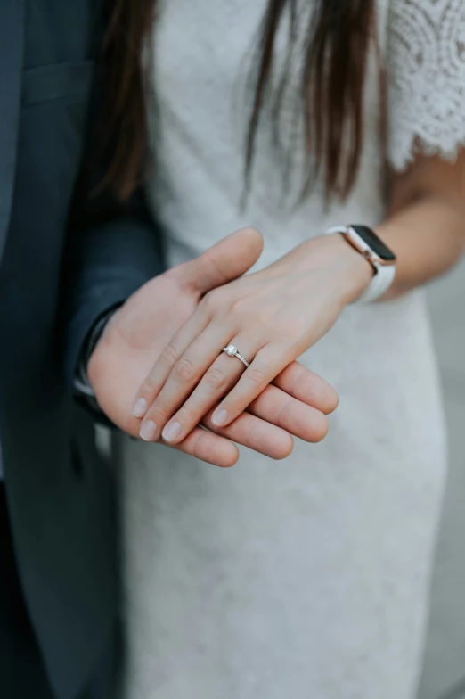 the groom and the bride are holding hands