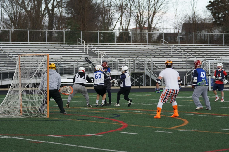 several boys in action on a lacrosse court