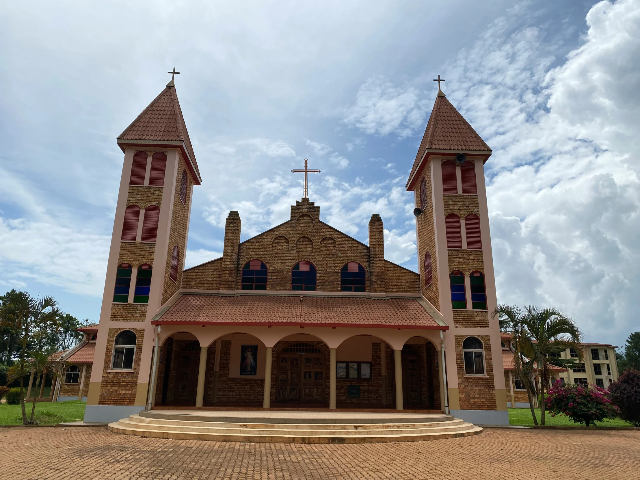 an old, tan church with red trim