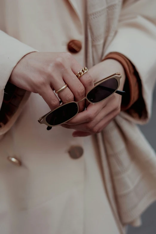 a woman holding some sort of thing that looks like glasses