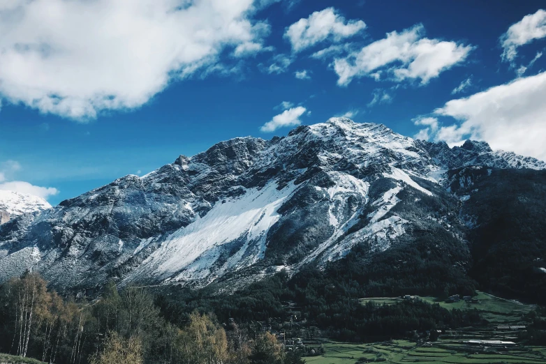 a mountain with snow on it during the day