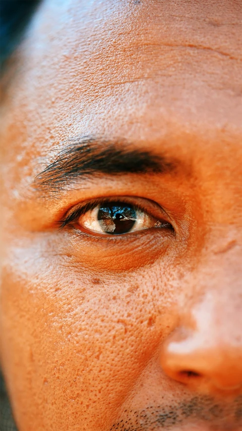 a man with brown eyes looking off into the distance