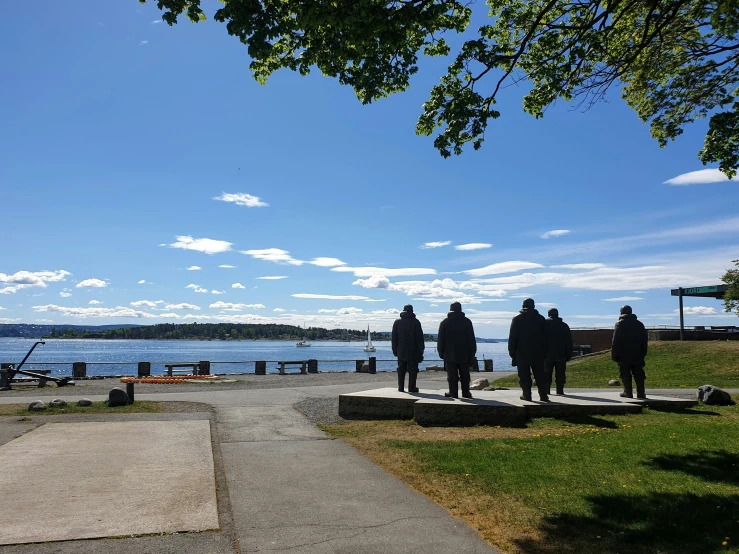 people with skateboards walk on a cement pathway