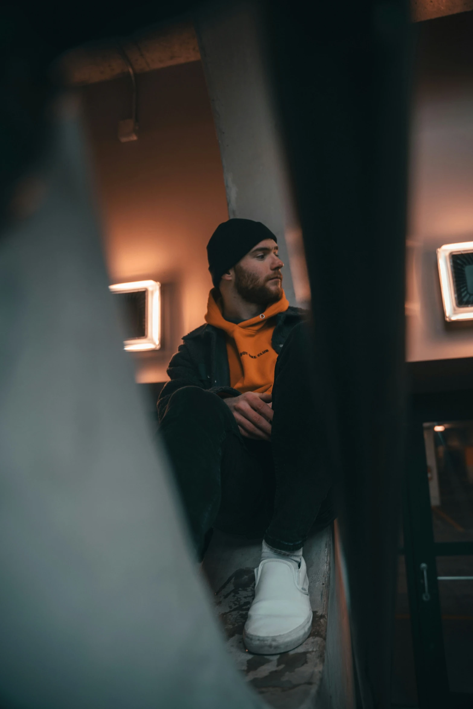 man sitting on the ground while staring into distance