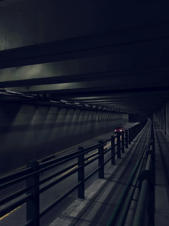 two cars on the street in a tunnel