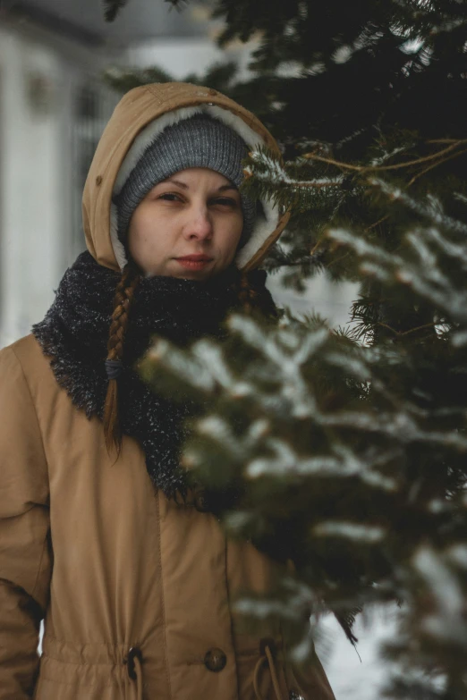 young lady wearing a warm coat and hat outside in the winter