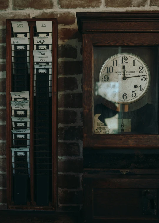 an old wooden wall clock with two pieces of electronic equipment