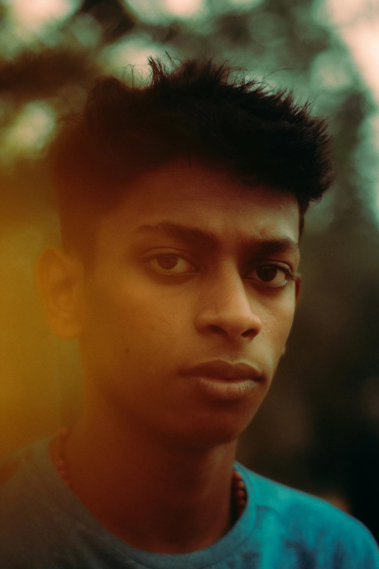 a young man with short hair looking at the camera