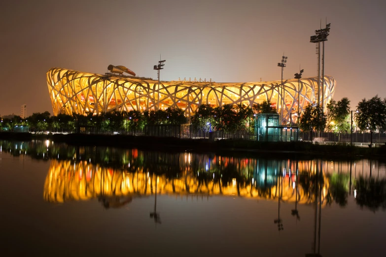 a stadium is lit up as the sun sets