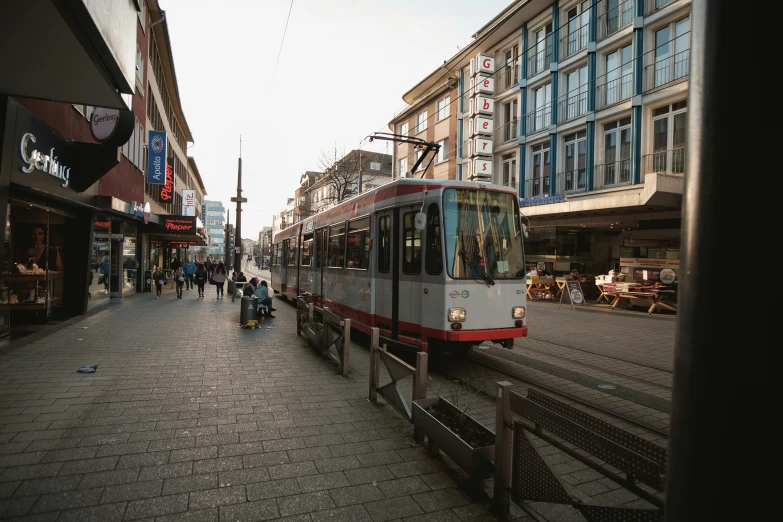 people walking on the sidewalk in an older city