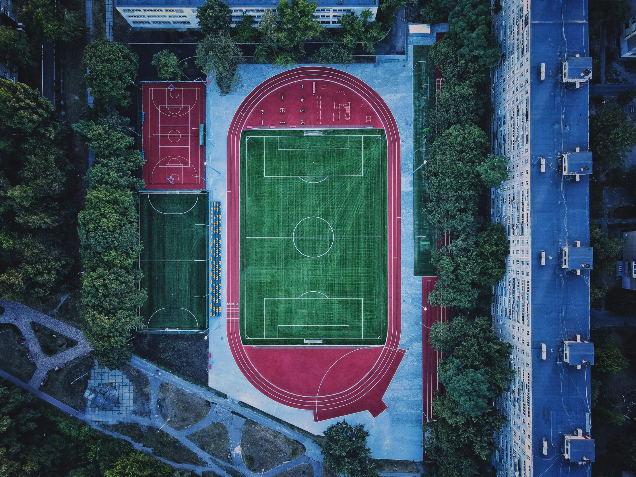 an aerial view of an empty soccer field in a city