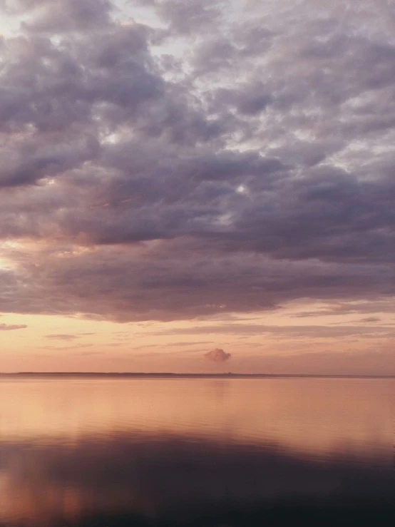 a boat that is sitting in the water at sunset