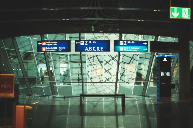 a building with an arched glass ceiling and a set of signs