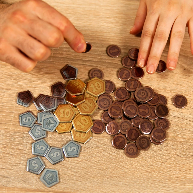 a wooden table filled with lots of coins