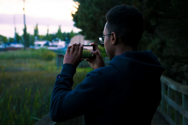 a man is taking a pograph while looking at the sky