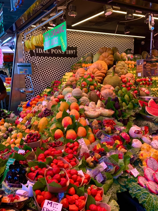 a large group of fruits and vegetables are being displayed for sale