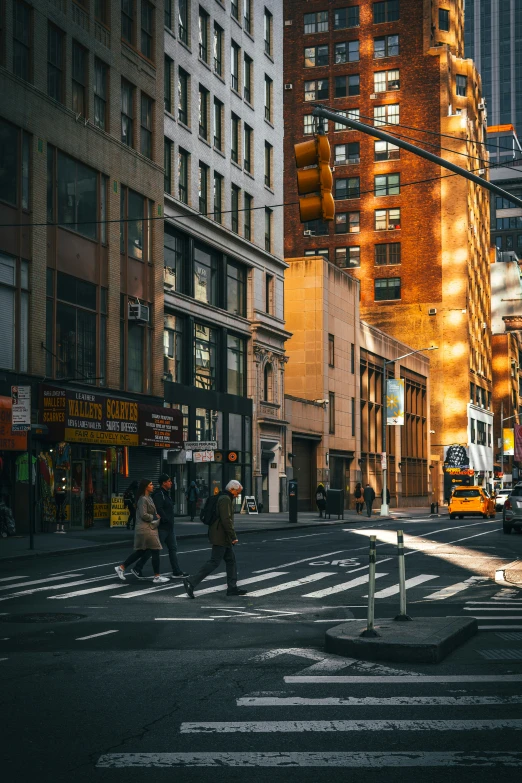 a man walks across the street in a city