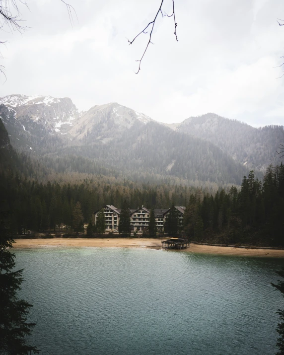 trees and building on a lake on a cloudy day