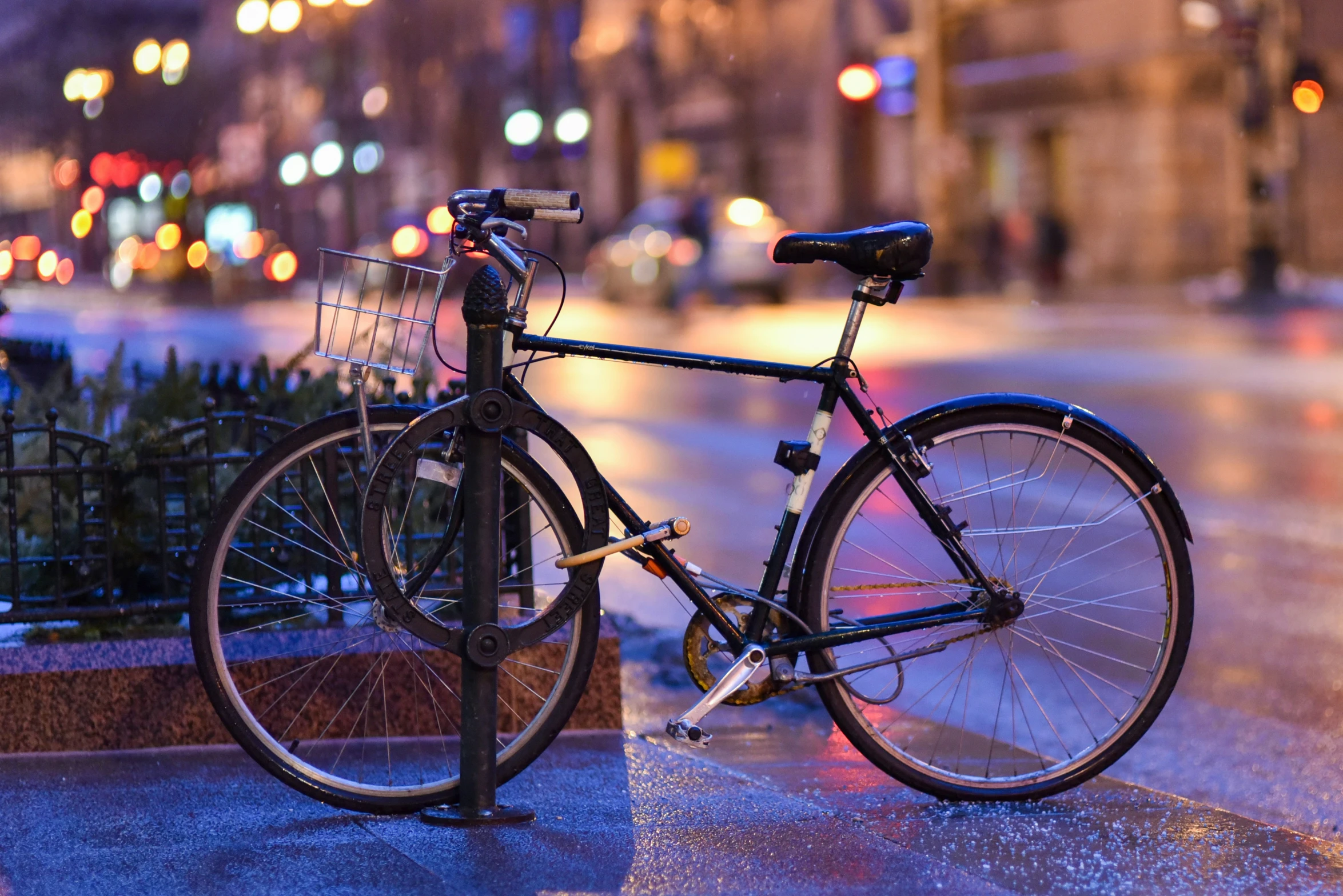 a bicycle parked on the side of a sidewalk