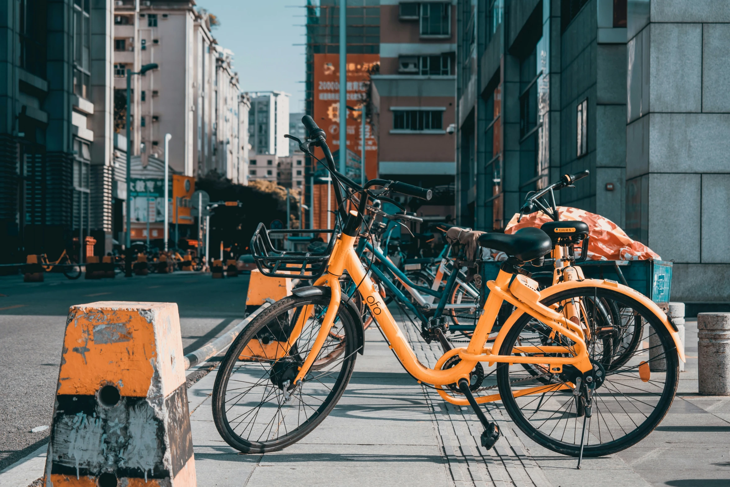 two bicycles are parked outside near an urban setting