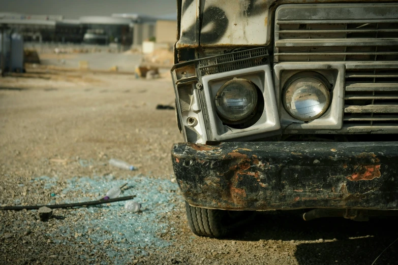 an old dirty truck with a broken front bumper