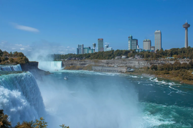 an image of a big waterfall with city on top