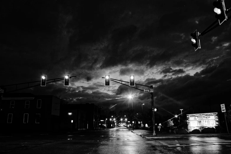 black and white image of a night city street with lights