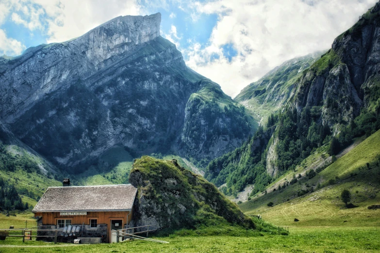 a mountain is shown in this view with a shack in the foreground